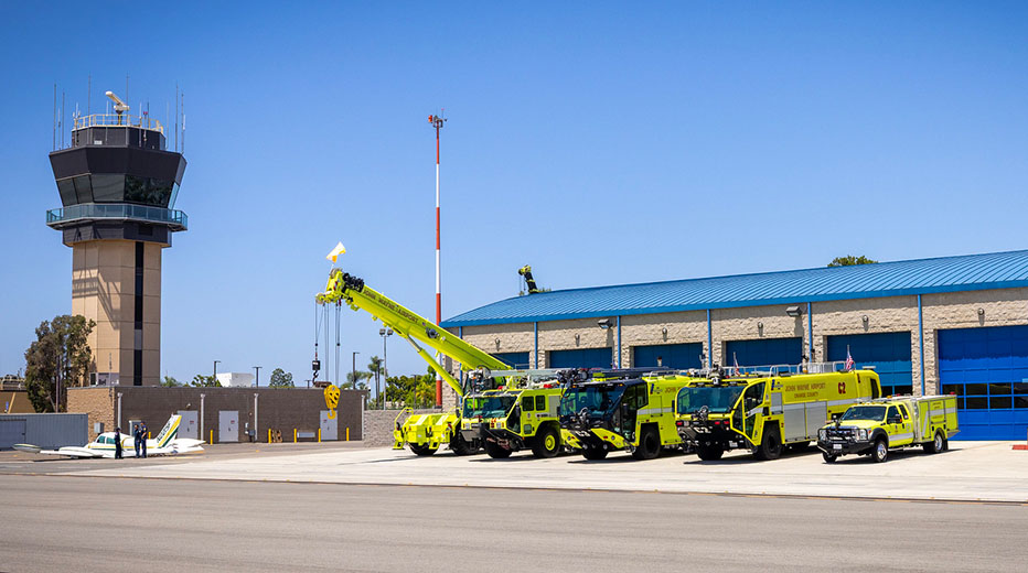 Airport rescue trucks parked in front of a station
