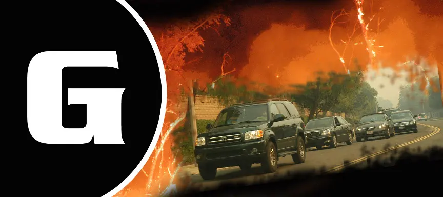 Large white "G" for "Go" beside a line of cars evacuating through orange smoke