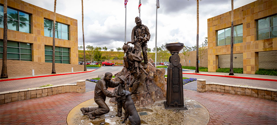 the Firefighter Memorial at OCFA Headquarters, which has a statue and an ever burning flame