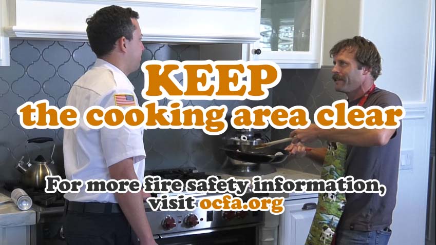 Cooking Safety - KEEP the cooking area clear. "Silly Steve" holds a frying pan and asks a male fire educator a question
