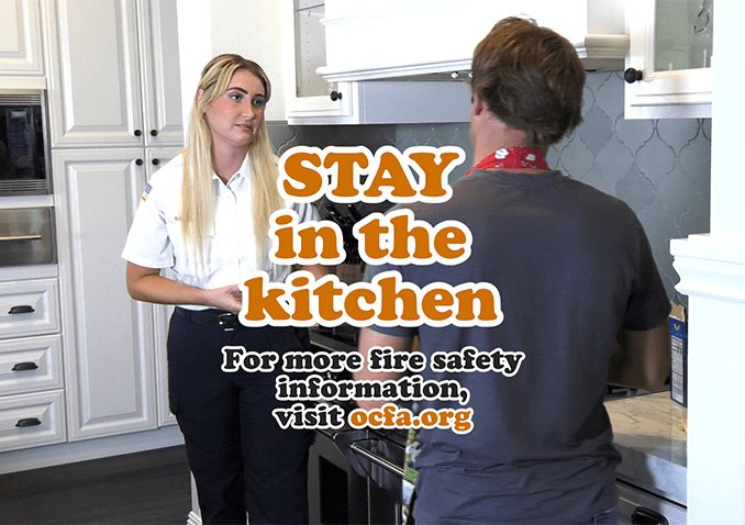 STAY in the Kitchen - A female educator stands in front of a stove and explains fire safety tips to "Silly Steve"